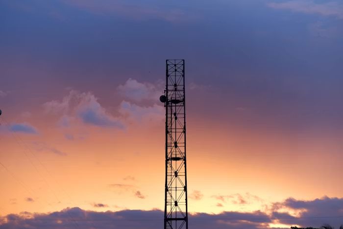 telecom tower against orange sky