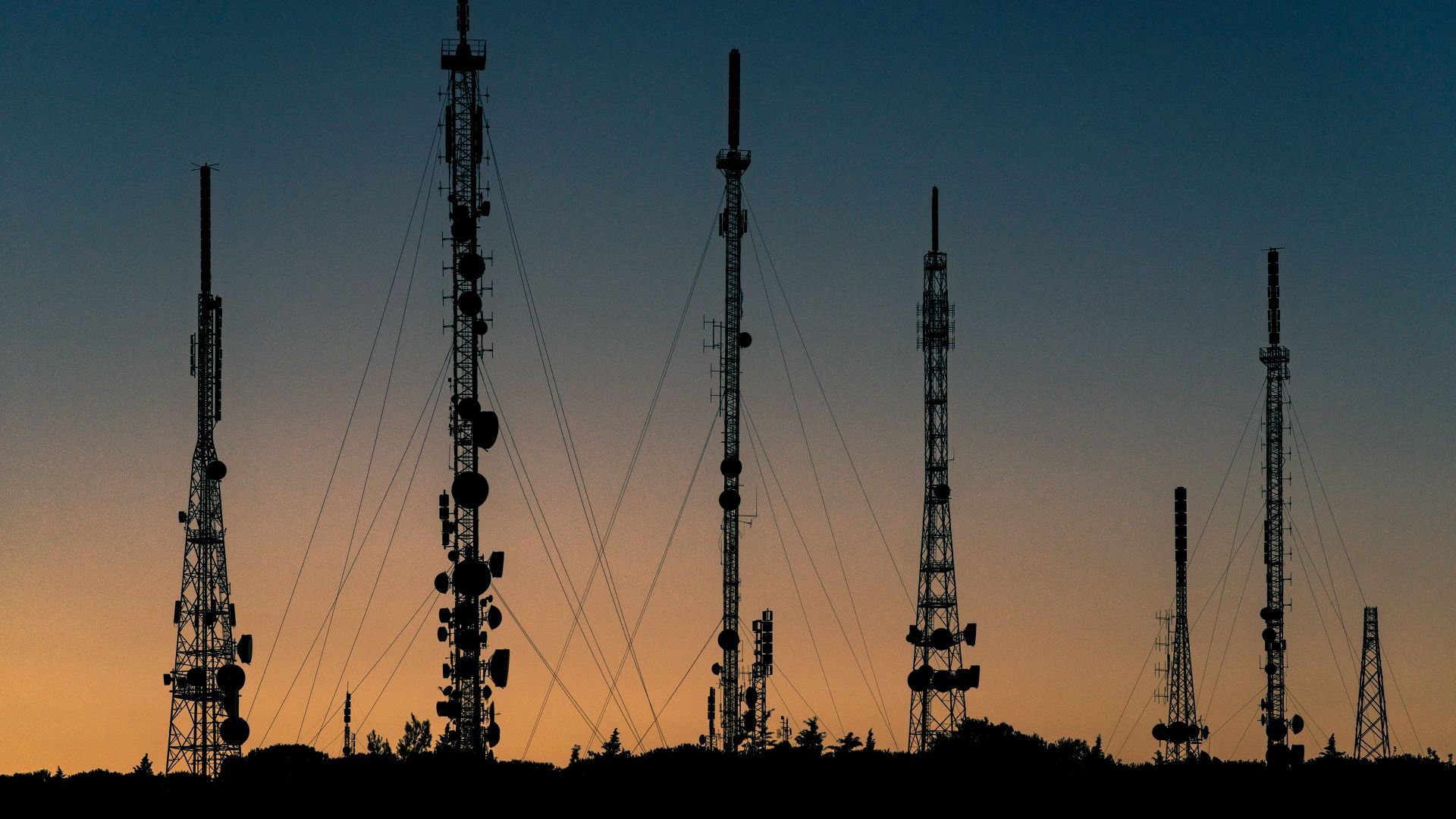 communications towers at dusk