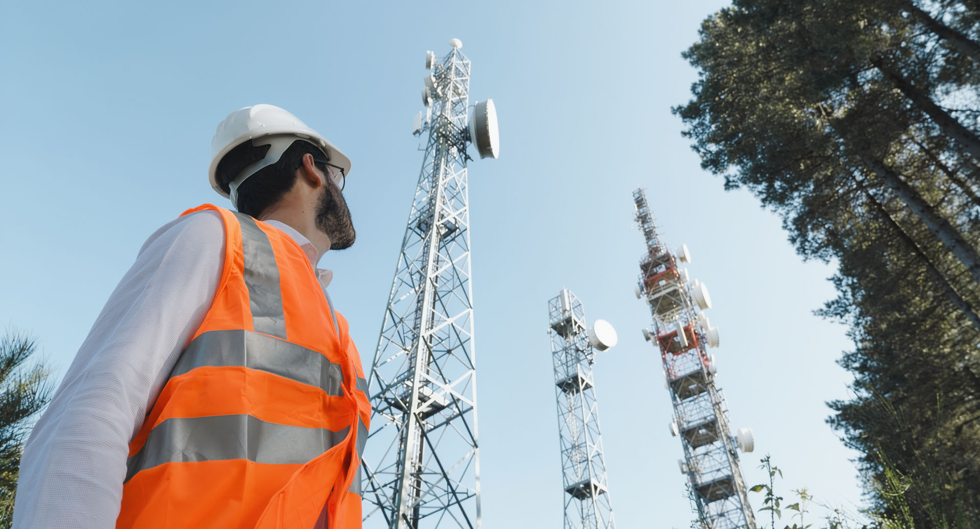 man looking at telecom towers